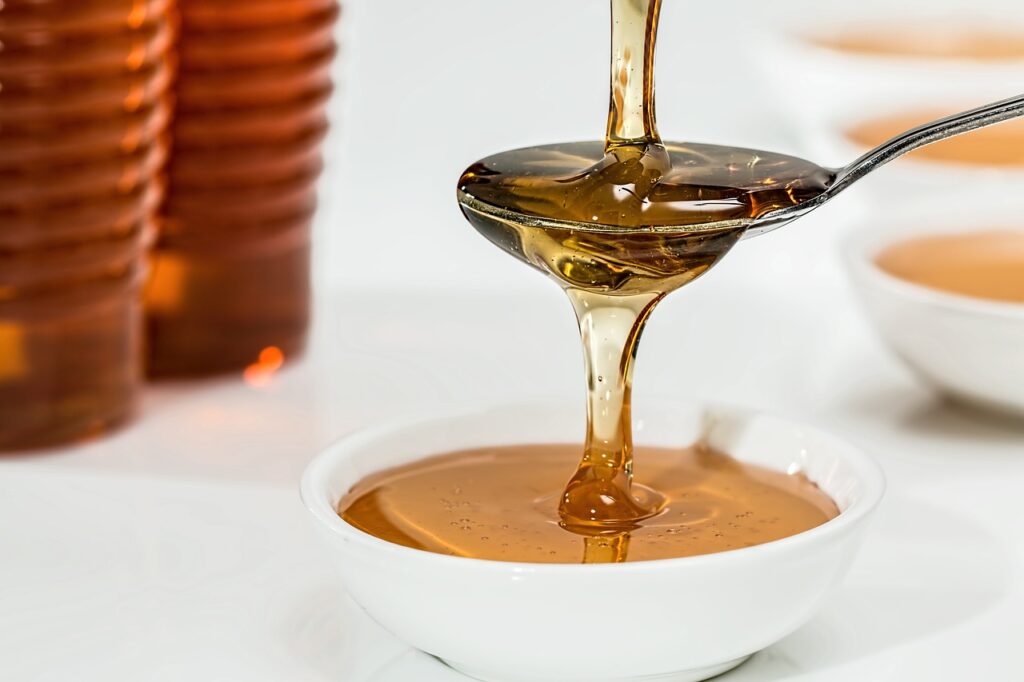 image of honey in a spoon the benefits of honey