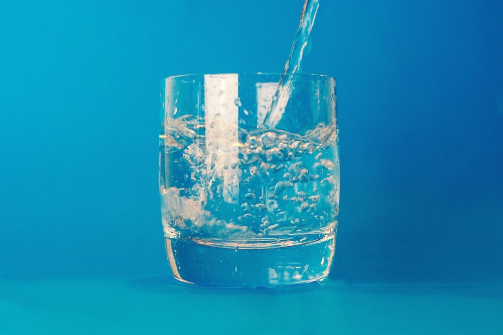 an image showing how much water you should really drink in a glass cup